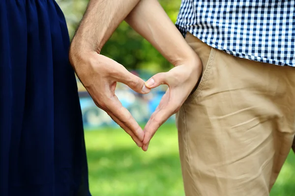 Young couple in love make heart — Stock Photo, Image