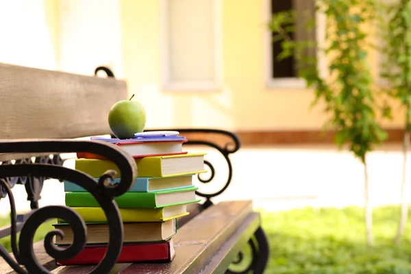 Stacked books on bench — Stock Photo, Image