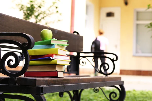 Stacked books on bench — Stock Photo, Image