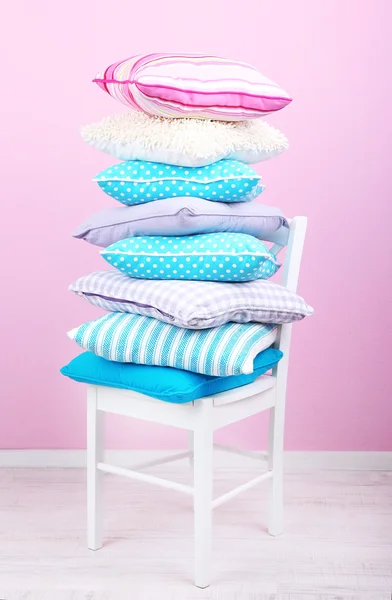 Bright pillows on chair — Stock Photo, Image