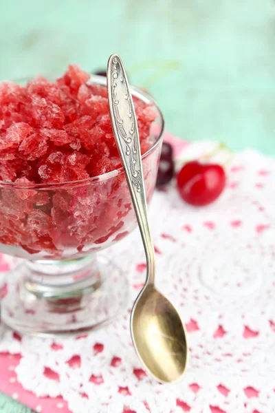 Closeup of cherry granita in glass bowl, on color wooden background — Stock Photo, Image