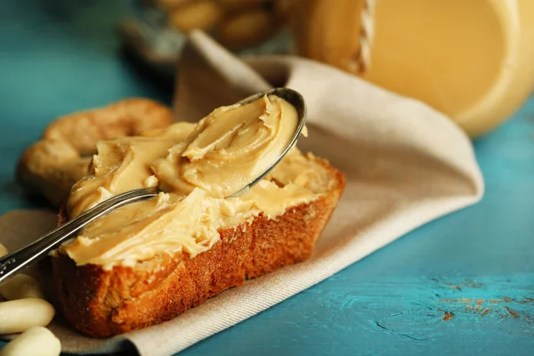 Tasty sandwich with fresh peanut butter on wooden background — Stock Photo, Image