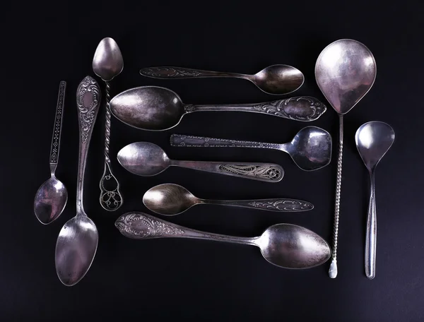 Metal spoons on black — Stock Photo, Image