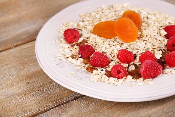 Big plate of oatmeal and berries on wooden background — Stock Photo, Image