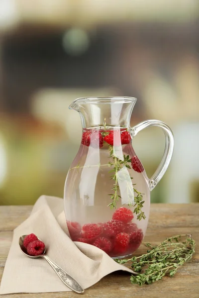 Tasty cool beverage with raspberries and thyme, on light background — Stock Photo, Image