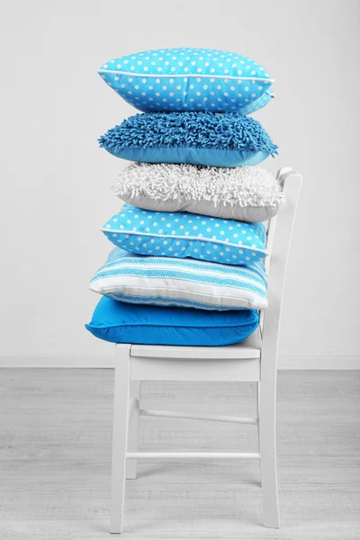 Bright pillows on chair — Stock Photo, Image