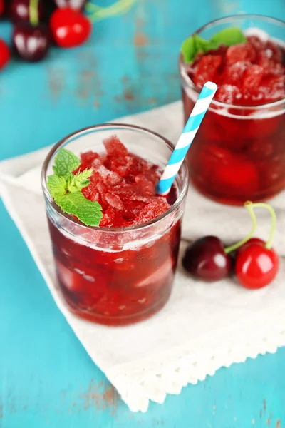 Closeup of cherry granita in glasses, on color wooden background — Stock Photo, Image
