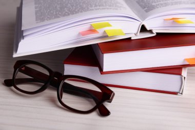 Books with bookmarks and glasses clipart