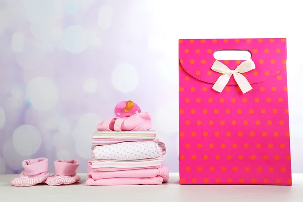 Baby clothes and gift bag — Stock Photo, Image