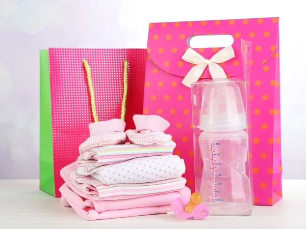 Baby clothes and gift bags — Stock Photo, Image