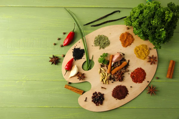 Schilderij palet met verschillende kruiden en specerijen, op een houten achtergrond kleur — Stockfoto