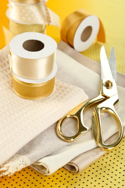 Ribbon with scissors and fabrics — Stock Photo, Image