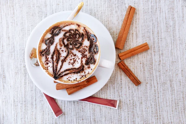 Cup of coffee with cute drawing on table, close up — Stock Photo, Image