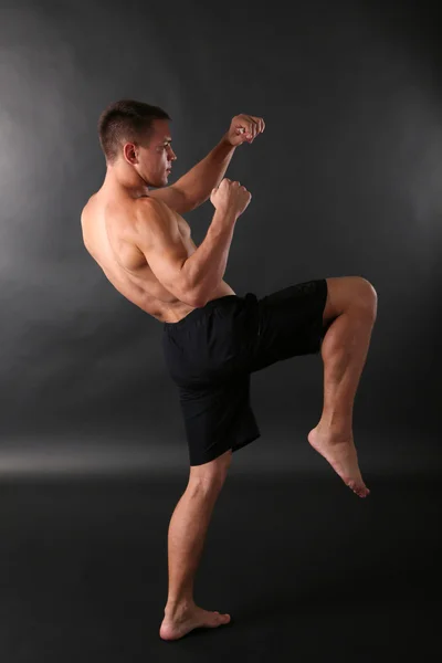 Handsome muscle young man on dark background — Stock Photo, Image