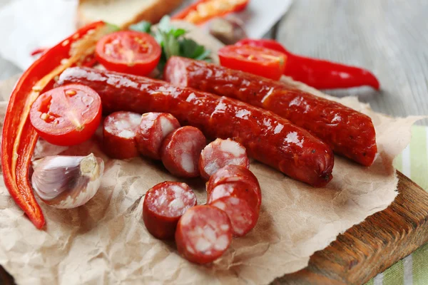 Smoked thin sausages and vegetables — Stock Photo, Image