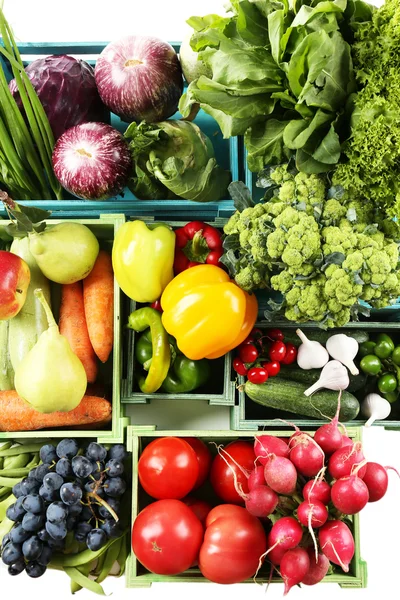 Fresh organic vegetables and fruits in wooden boxes, close up — Stock Photo, Image