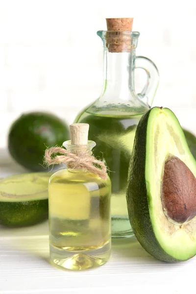 Avocado oil on table — Stock Photo, Image