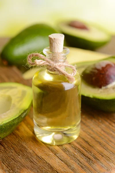 Avocado oil on table — Stock Photo, Image