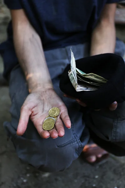 Homeless beggar with  money — Stock Photo, Image