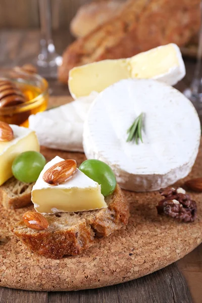 Camembert cheese on paper — Stock Photo, Image
