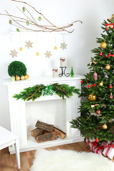 Christmas tree near fireplace in room
