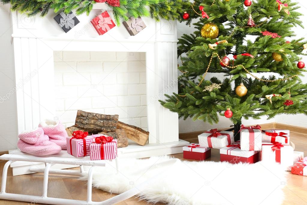 Fireplace with beautiful Christmas decorations in room