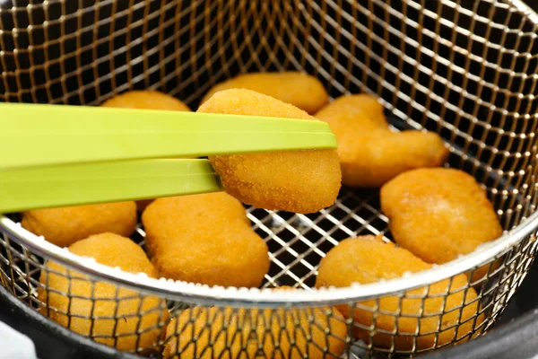 Cutlets in deep fryer — Stock Photo, Image