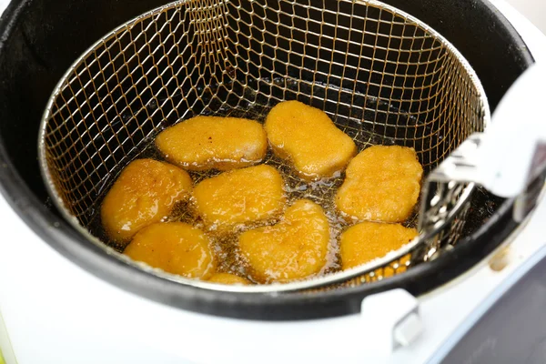 Cutlets in deep fryer — Stock Photo, Image