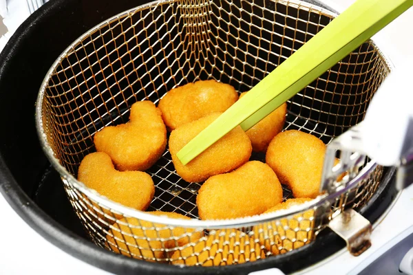Cutlets in deep fryer — Stock Photo, Image
