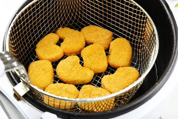 Cutlets in deep fryer — Stock Photo, Image