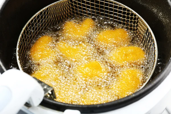 Cutlets in deep fryer — Stock Photo, Image