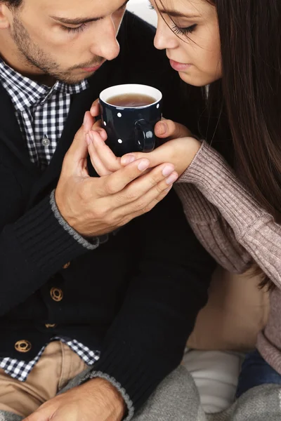 Young couple drinking tea, close-up — Stock Photo, Image