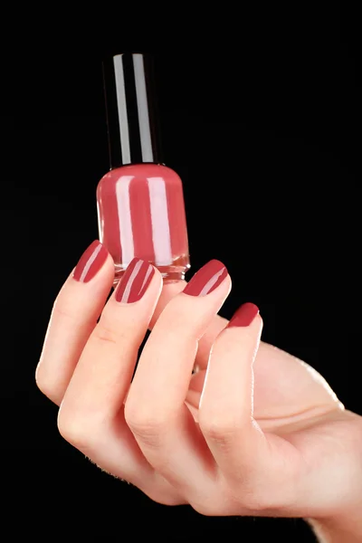 Nail polish in hand, close-up — Stock Photo, Image