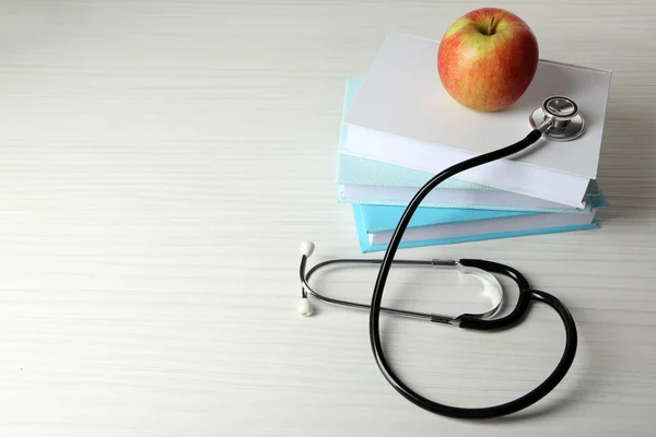 Medical stethoscope with apple — Stock Photo, Image