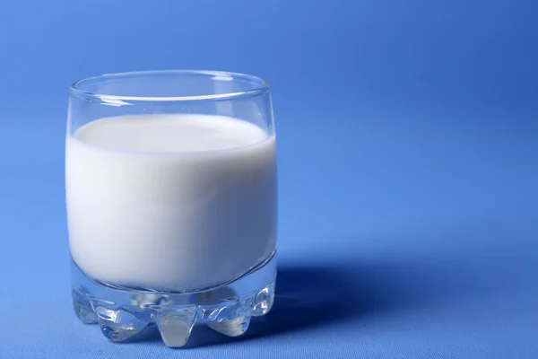 La leche en el vaso sobre azul —  Fotos de Stock