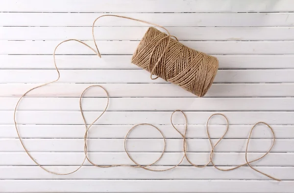 Love word formed with rope on wooden background — Stock Photo, Image