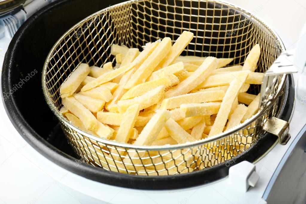 French fries in deep fryer, closeup