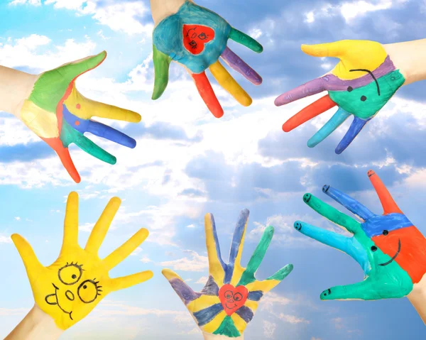 Painted hands on sky background — Stock Photo, Image