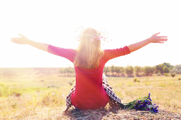 Woman waiting for summer sun on meadow