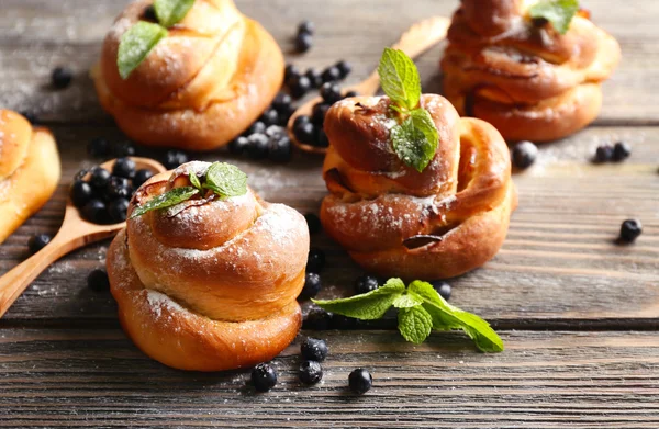 Tasty buns with berries on table close-up — Stock Photo, Image