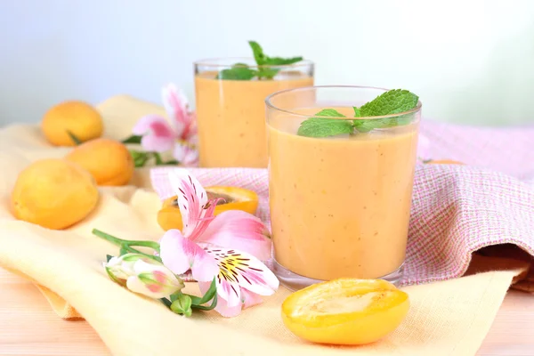 Apricot dessert in glasses on table on bright background — Stock Photo, Image