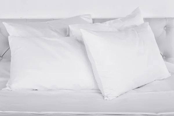 Белые подушки на кровати в номере — стоковое фото