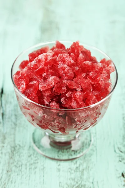 Closeup of cherry granita in glass bowl, on color wooden background — Stock Photo, Image