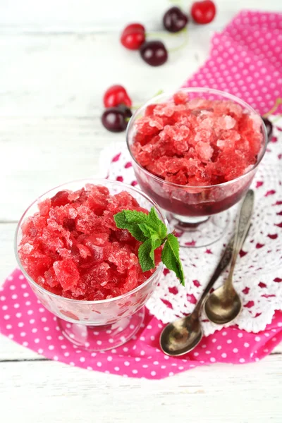 Closeup of cherry granita in glass bowl, on color wooden background — Stock Photo, Image