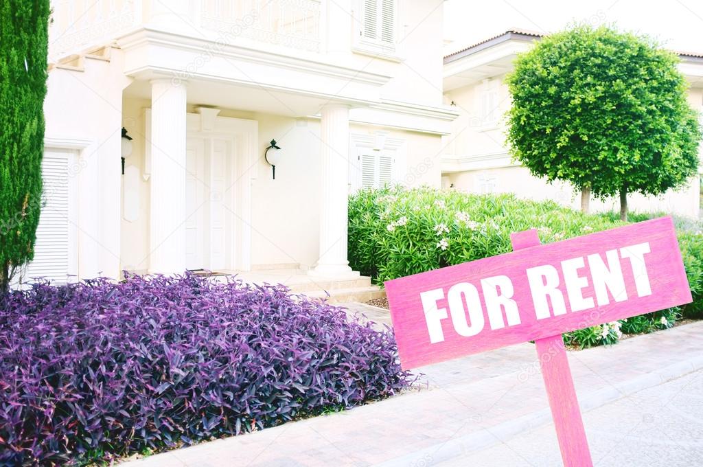 Real estate sign in front of new house for rent