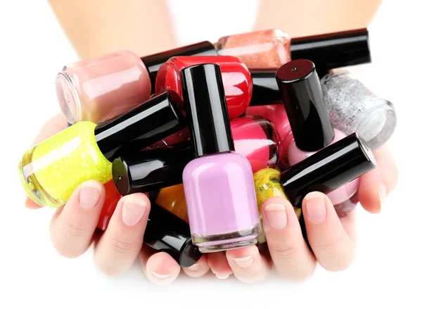 Colorful nail polishes in hands — Stock Photo, Image