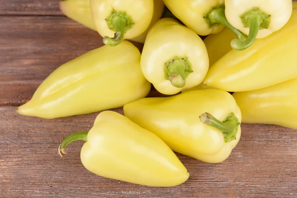 Yellow peppers on wooden background — Stock Photo, Image