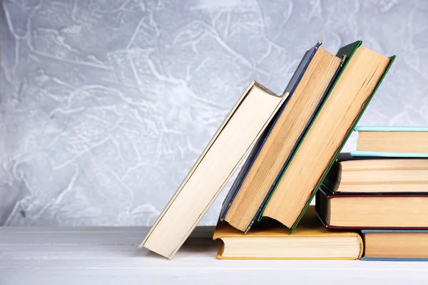 Books on wooden table on light background — Stock Photo, Image