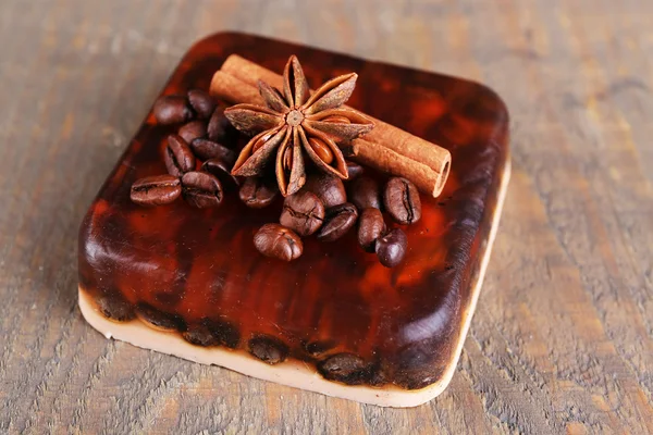 Organic soap with coffee beans and spices on wooden background — Stock Photo, Image