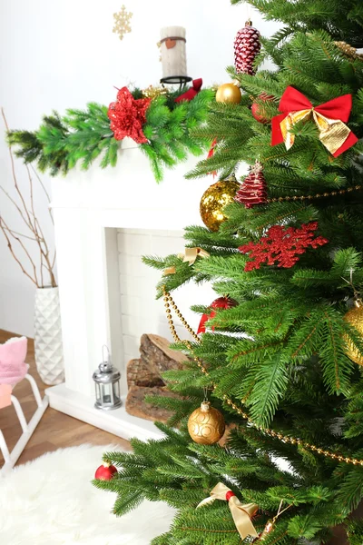 Christmas tree near fireplace — Stock Photo, Image